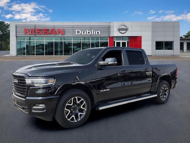 2025 RAM 1500 Laramie 4x4 Crew Cab 5'7" Box in Diamond Black Crystal Pearlcoat — front three-quarter view